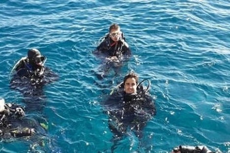 a group of people swimming in a pool of water