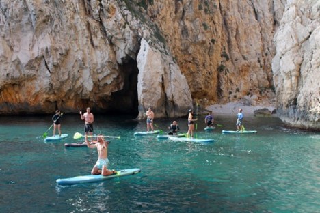 a group of people paddling in the water