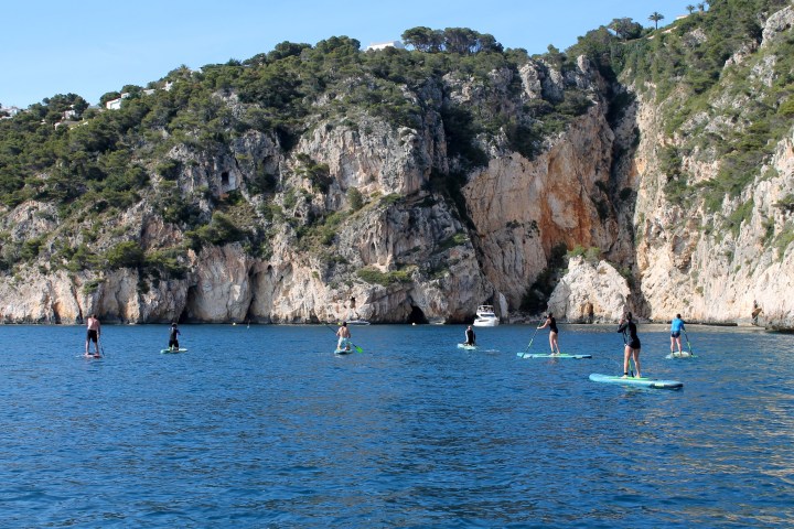 a group of people paddling in a large body of water
