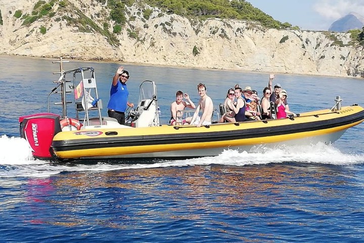 a group of people in a small boat in a body of water