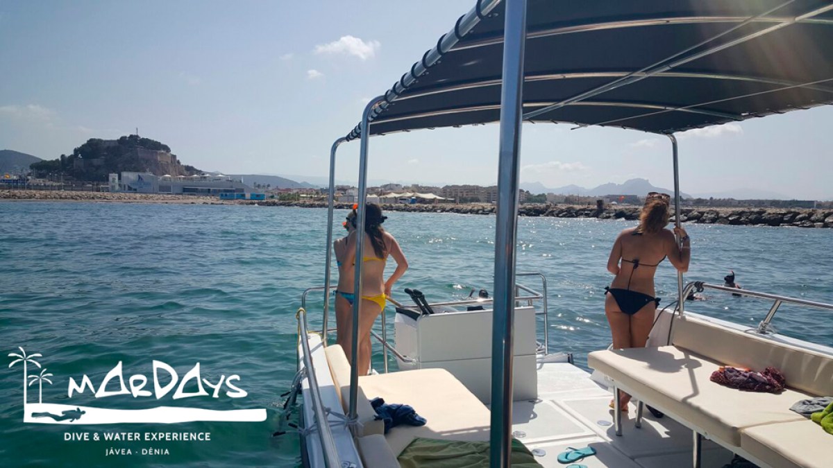 a group of people standing on a boat in the water