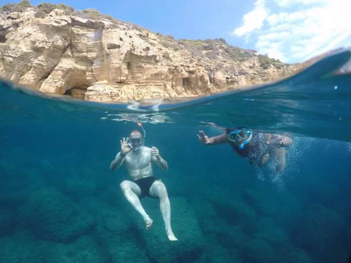 a pair of people swimming in the water