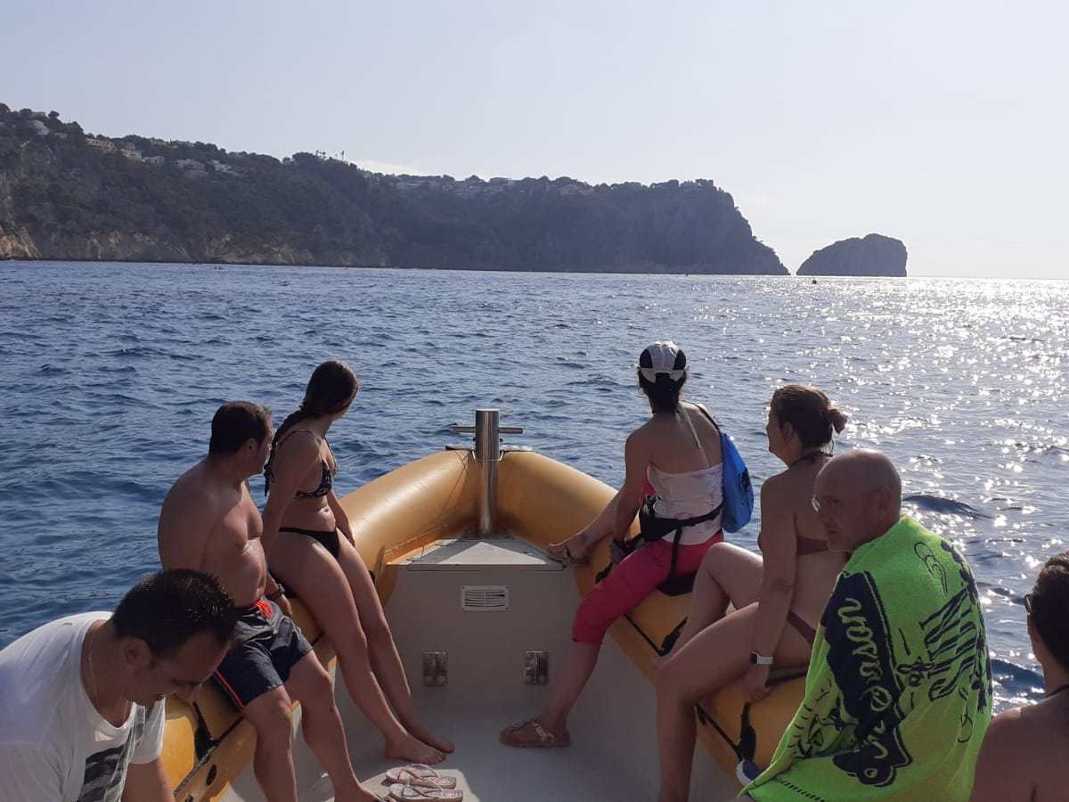 a group of people in a boat on a body of water