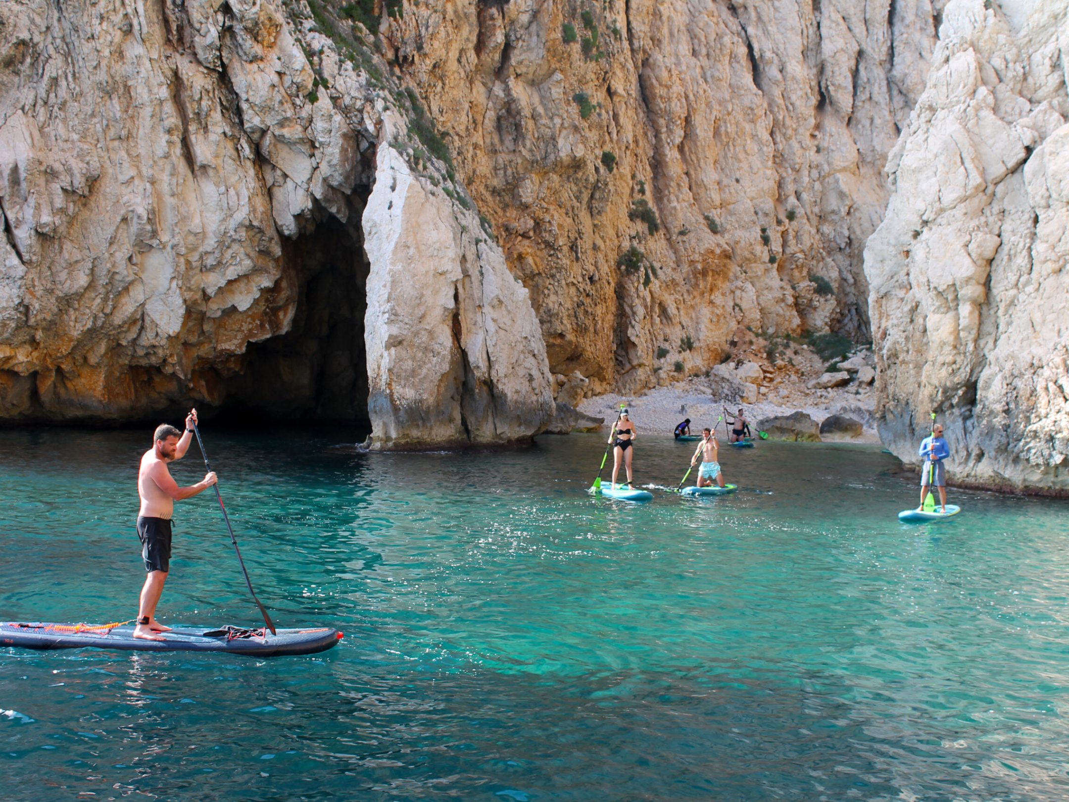 a group of people paddling on the water