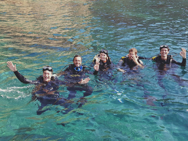 a group of people swimming in a body of water